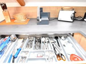 a drawer filled with utensils in a kitchen at Scenic Apartment with Balcony Garden Deckchairs Barbecue in Gleißenberg