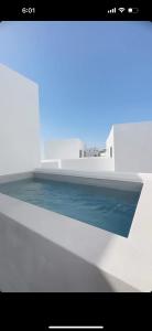 a rendering of a room with water and a building at Poema Antiparos in Antiparos Town