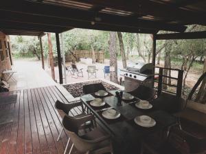 un tavolo e sedie su una terrazza con griglia di HUIS ASEM a Marloth Park