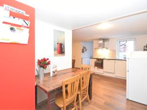 a kitchen and dining room with a wooden table and chairs at Holiday home in ldernTwistetal Oberwaro with sauna in Oberwaroldern