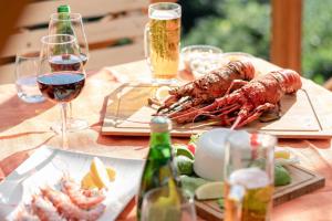 a table with two plates of lobster and glasses of wine at VIVA SUMOTO - Vacation STAY 81374v in Amakusa
