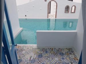 a bathroom with a mosaic floor and a bath tub at Ipoh Santorini Hideaway - Hotel Inspired in Ipoh