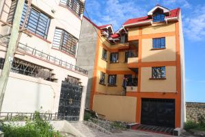 a building with a gate in front of it at Zedek Furnished Apartment 102 in Nairobi