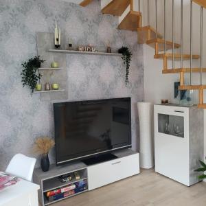 a living room with a large flat screen tv at Ferienhaus mit Terrasse - Wallbox in Bad Oeynhausen