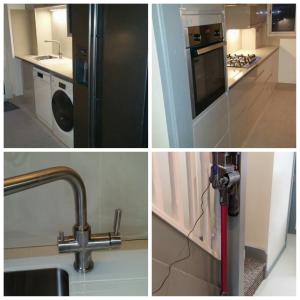 a kitchen with a black refrigerator and a sink at Luxurious En-suite Soft Water Air Conditioning TV ETHERIUM in London