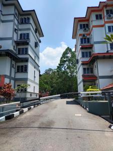 a street between two tall buildings at 3 Bedrooms 2 Bathrooms Seruni Apartment, Serendah Gold Resort, Persiaran Meranti Selatan, Ulu Selangor, 48200 in Serendah