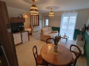 a living room with a table and a couch at Un Nid en Sologne in Contres