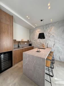 a kitchen with a large island in the middle at Poema Antiparos in Antiparos