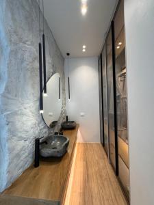 a bathroom with a sink and a stone wall at Poema Antiparos in Antiparos