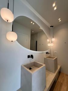 a bathroom with a sink and a mirror at Poema Antiparos in Antiparos