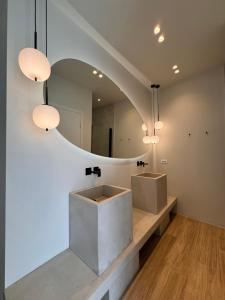 a bathroom with a sink and a mirror at Poema Antiparos in Antiparos