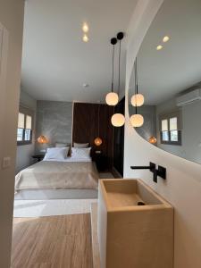 a bedroom with a bed and a large mirror at Poema Antiparos in Antiparos