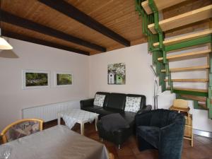 a living room with a couch and a table at Tasteful Holiday Home in Neubukow with Terrace in Neubukow