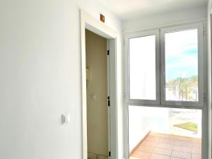 eine offene Tür zu einem Zimmer mit Meerblick in der Unterkunft Attractive apartment in Roquetas de Mar with terrace in Roquetas de Mar