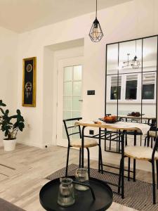 a living room with a dining room table and chairs at Centar City Sarajevo Apartman in Sarajevo