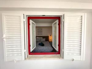 a view of a room with a bedroom through a window at Old Fisherman's Corner 10 - Centro Old Town Albufeira in Albufeira