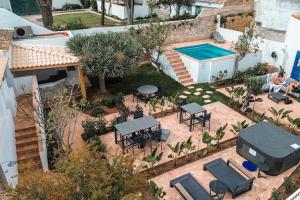 an aerial view of a patio with tables and a swimming pool at Old Fisherman's Corner 10 - Centro Old Town Albufeira in Albufeira