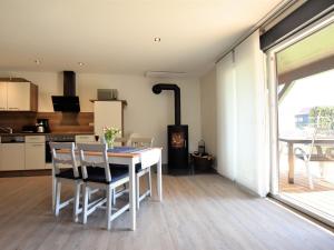 a kitchen and dining room with a table and chairs at Cozy Apartment in Barnekow with Private Terrace in Barnekow