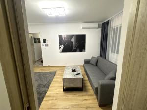 a living room with a couch and a coffee table at Casa Darius 2 in Alexandria +2 photos