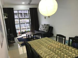 a dining room with a table and chairs and a room with a window at Palas Horizon in Kabus in Brinchang