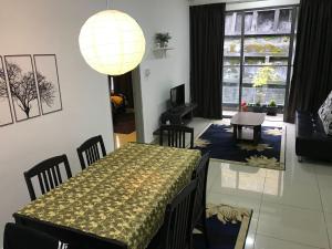 a dining room with a table and chairs and a lamp at Palas Horizon in Kabus in Brinchang