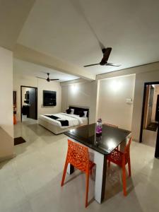 a living room with a bed and a table and chairs at Hotel Grand Resort 2 Puri Sea View Room - Swimming Pool - Lift Facilities - Best Seller in Puri