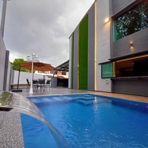 a swimming pool in the middle of a building at LYL Jaccuzi Private Pool House in Ipoh