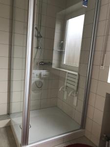 a shower with a glass door in a bathroom at Business Apartment in Weiden