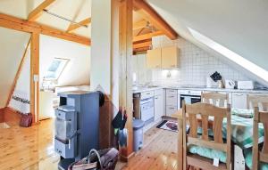 a kitchen with white cabinets and a wooden floor at Stunning Apartment In Jabel Ot Loppin With Kitchen in Loppin