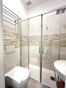 a bathroom with a shower and a toilet and a sink at Hotel Baia di Levanto in Levanto