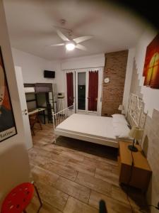 a bedroom with a bed and a ceiling fan at Europe Station Rooms in Parma