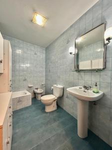 a bathroom with a sink and a toilet and a mirror at Del Valle 3 in Cudillero +31 photos