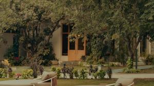 a house with a door in the middle of a yard at Giovanni Village Resort in Bhopal