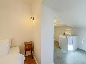 a bedroom with a bed and a bathroom with a sink at Cours Saleya - Wifi, AC, 2pers, aperçu mer in Nice