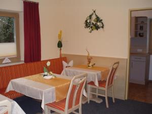 a dining room with two tables and chairs at Haus Wiesenblick in Längenfeld