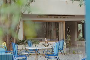 a table and chairs in front of a building at Giovanni Village Resort in Bhopal