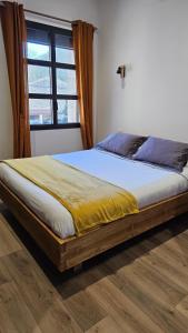 a large bed in a bedroom with a window at Les Marronniers in Lavérune +149 photos