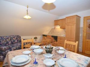a kitchen with a table with plates on it at Spacious Apartment with Sauna in Schonsee in Dietersdorf