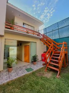 a house with a staircase in front of it at Casa Mahulu in Paracas