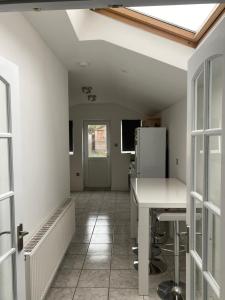 a kitchen with a table and a refrigerator in a room at Heart of Oxford in Oxford