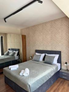 a bedroom with a large bed and a mirror at WEST POINT DELUXE APARTMENT in Plovdiv