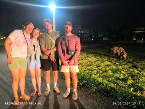 a group of people posing for a picture at night at Hotel National Park Sauraha- Homely Stay and Peaceful Location in Sauraha