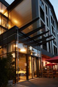 a building with large glass windows and a building at Hotel Zum Goldenen Hirsch in Sonthofen