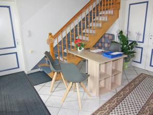 a room with a desk and two chairs and a staircase at Apartment in Schultenbrook with garden in Metelsdorf