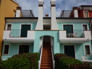 a house with a staircase leading up to it at Le Briccole in Cavallino-Treporti