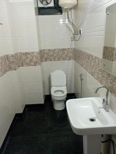 a bathroom with a white toilet and a sink at The relax in hotel in Katra