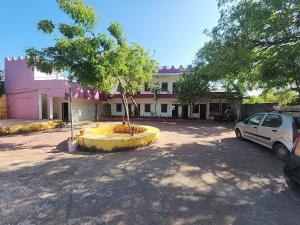 a car parked in a parking lot in front of a building at Paradise Feel Dreamy Resort in Puducherry