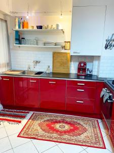 een keuken met rode kasten en een rood tapijt bij Montpellier Gare District in Montpellier