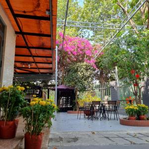 an outdoor patio with tables and chairs and flowers at Biệt thự Thu Le in Ho Chi Minh City