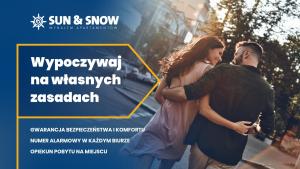 a poster of a man and a woman standing on a street at Apartamenty Sun & Snow Zapach Lasu - Naturalne SPA in Karwica